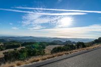 Dawn Sunlight over Highland Landscape with Asphalt Road