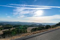 Dawn Sunlight over Highland Landscape with Asphalt Road