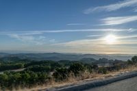 Dawn Sunlight over Highland Landscape with Asphalt Road