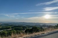 Dawn Sunlight over Highland Landscape with Asphalt Road