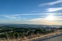 Dawn Sunlight over Highland Landscape with Asphalt Road