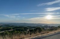 Dawn Sunlight over Highland Landscape with Asphalt Road