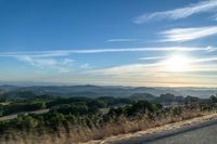 Dawn Sunlight over Highland Landscape with Asphalt Road