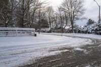 snow covers the road of a suburban park in the morning light, during a very snowy day