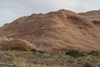 Dawn in Utah's Desert: Red Rocks and Mountains