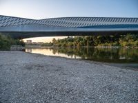 there are two very long bridges that are above the river shore at dusk here, and you can see how close them are