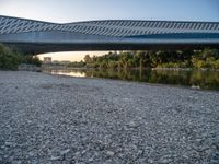 there are two very long bridges that are above the river shore at dusk here, and you can see how close them are