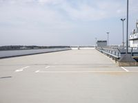 a boat is parked in an empty parking lot near an air port on the water