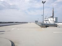 a boat is parked in an empty parking lot near an air port on the water