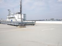 a boat is parked in an empty parking lot near an air port on the water