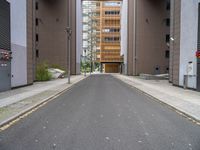 a street with no vehicles in the middle of it and two buildings that look side by side