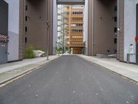 a street with no vehicles in the middle of it and two buildings that look side by side