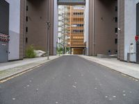 a street with no vehicles in the middle of it and two buildings that look side by side