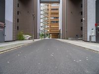 a street with no vehicles in the middle of it and two buildings that look side by side