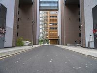 a street with no vehicles in the middle of it and two buildings that look side by side