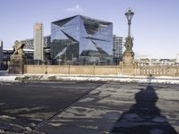 the shadow of a person is reflected in a building in the center of the city