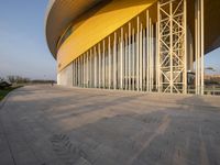 a view of the outside of an abstract building, showing the curved roof and curved entrance