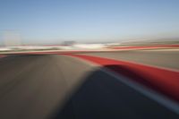 Daytime Highway: Red Car Against a Clear Sky