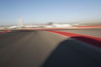 Daytime Highway: Red Car Against a Clear Sky