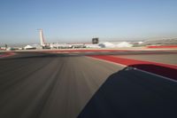 Daytime Highway: Red Car Against a Clear Sky