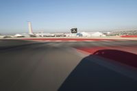 Daytime Highway: Red Car Against a Clear Sky