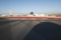 Daytime Highway: Red Car Against a Clear Sky
