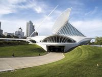 a building designed like a flying whale with modern architecture in the background, on the park area