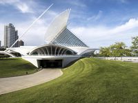 a building designed like a flying whale with modern architecture in the background, on the park area