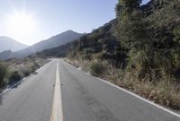 Daytime Mountain Road: Asphalt Across Mountain Landforms