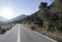 Daytime Mountain Road: Asphalt Across Mountain Landforms