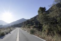 Daytime Mountain Road: Asphalt Across Mountain Landforms