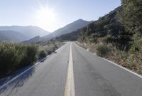 Daytime Mountain Road: Asphalt Across Mountain Landforms