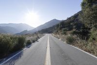 Daytime Mountain Road: Asphalt Across Mountain Landforms