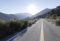 Daytime Mountain Road: Asphalt Across Mountain Landforms