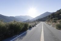 Daytime Mountain Road: Asphalt Across Mountain Landforms