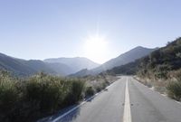 Daytime Mountain Road: Asphalt Across Mountain Landforms