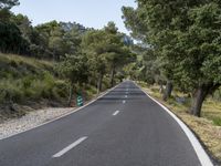 a long, straight road is empty from motor traffic or other traffic on it's sides