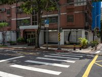 two yellow lines on the street in front of a tall building with large windows and a tree