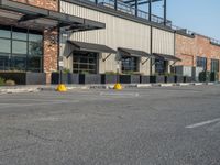 the empty street outside of the business district is empty and deserted with vehicles parked in it