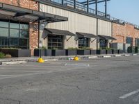 the empty street outside of the business district is empty and deserted with vehicles parked in it