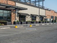 the empty street outside of the business district is empty and deserted with vehicles parked in it