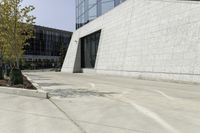 a street scene with focus on the parking lot in front of the building and trees