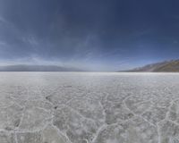 a wide angle view of the sky and land from a high vantage over the desert