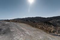 the sun shines brightly over a rocky mountain in death valley national park, california