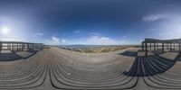 a view into a fish eye lens looking down on the boardwalk of a boardwalk area