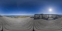 the sun is shining on this wide angle 360 - panoramic photograph of some wooden benches