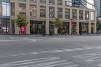 a cross walk that is by some buildings in the city center of a city area