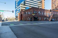 a building sitting on the corner of a street next to a stoplight and a road