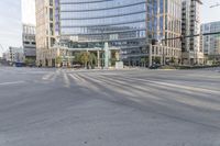 the view of the city street is empty and the intersection is clear of traffic lights