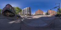 a photo taken from a fisheye lens of a street in a town showing a pedestrian crossing